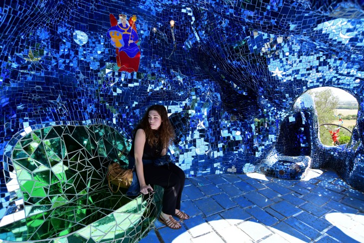 A woman takes in a shady part of a mirrored sculpture in Il Giardino dei Tarocchi in Capalbio, Italy on Wednesday, June 15, 2016. The garden is comprised of over 20 sculptures depicting tarot cards.